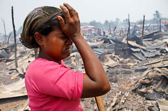 Rohyinga Muslim girl looking over destroyed village. 