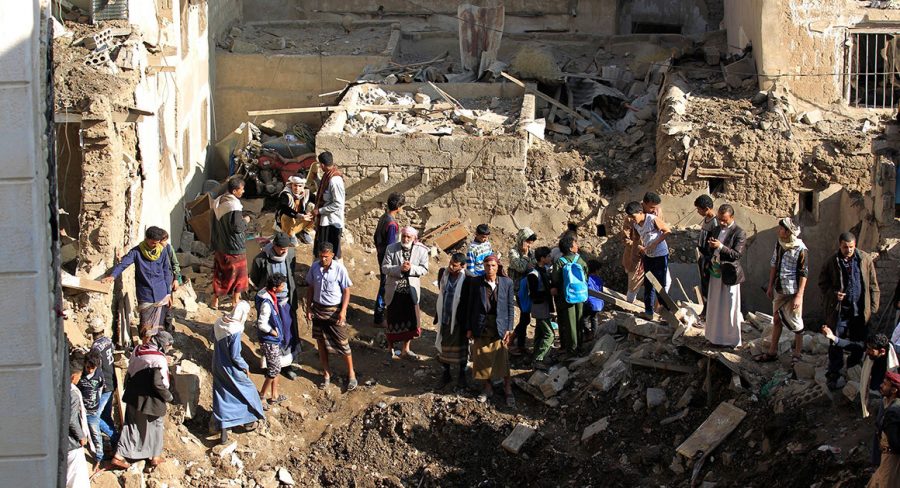 People examining damage done by an airstrike in the Yemeni capital. 