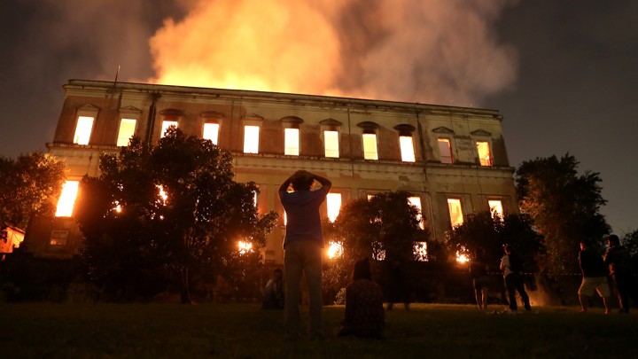 People watch as a fire burns at the National Museum of Brazil in Rio de Janeiro, Brazil September 2, 2018. 