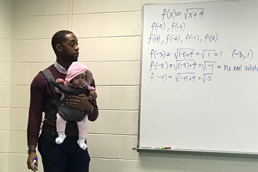 Professor Nathan Alexander holding five-month old Asada.