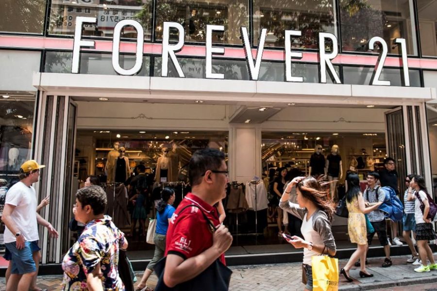 Shoppers and pedestrians walk past a Forever 21 Inc. clothing store in the Causeway Bay shopping district of Hong Kong, China. 