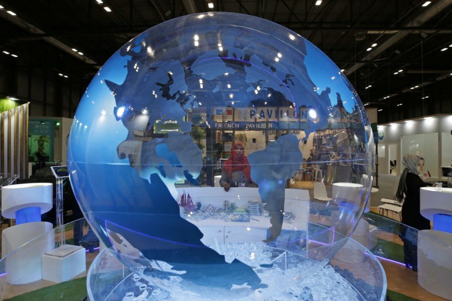 A woman looks at a World globe at the United Nations climate talks in Madrid, Spain, on Friday. Officials from almost 200 countries met for two weeks to work on policy recommendations to deal with the climate crisis. Several issues have been pushed to the next climate conference in November 2020. 