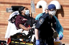 Emergency medical technicians bring a patient into Wyckoff Heights Medical Center in Brooklyn, New York, on Monday.