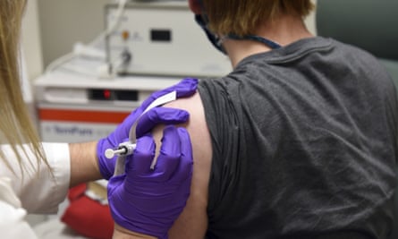 A woman getting a vaccine delivered.