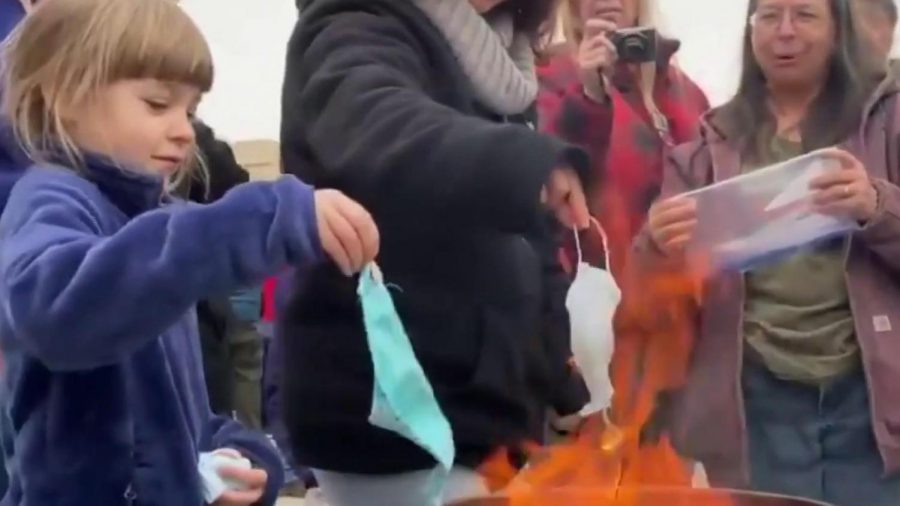 Children and adults burning their masks in front of Idahos state capital. 