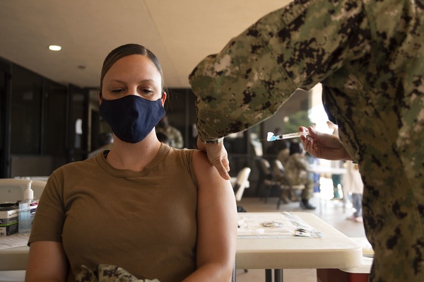 Woman receiving a COVID vaccine.