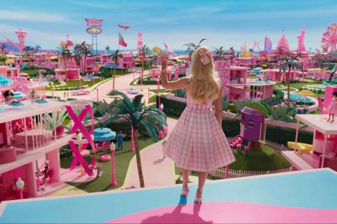 Barbie waving to the overview of her city.
