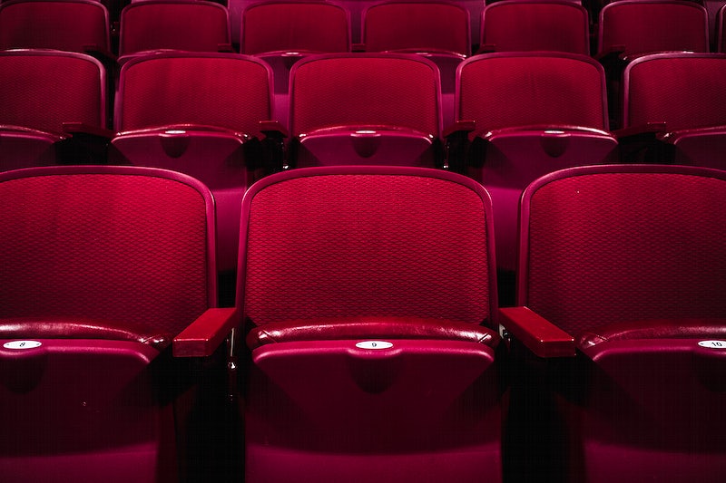 A photograph of empty theatre seats.