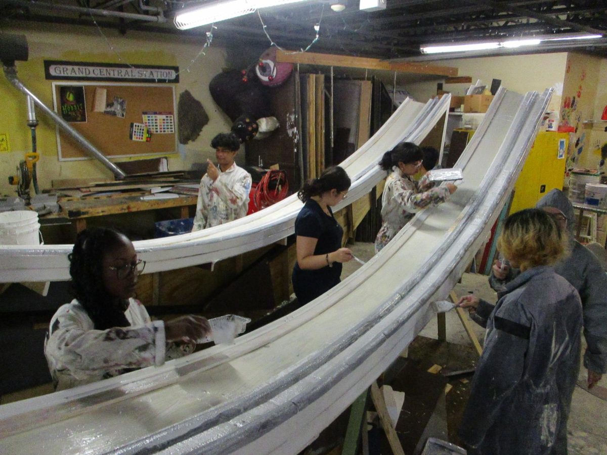 A group of Tech majors painting the set of Hamlet.