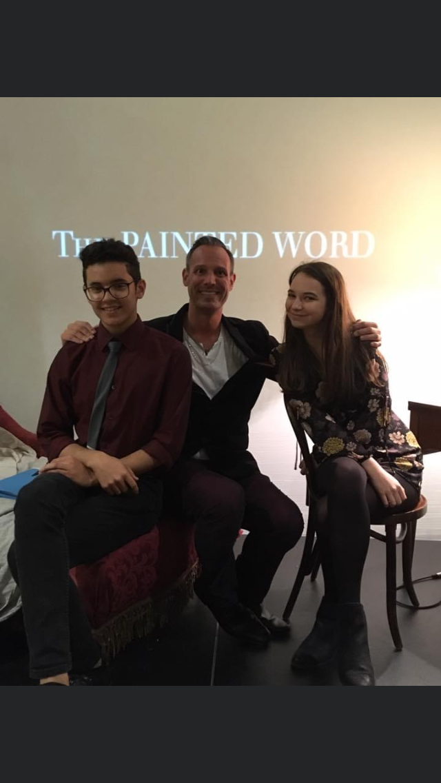 Mr. Capley and two OCSA alumni on stage at a past Painted Word event.