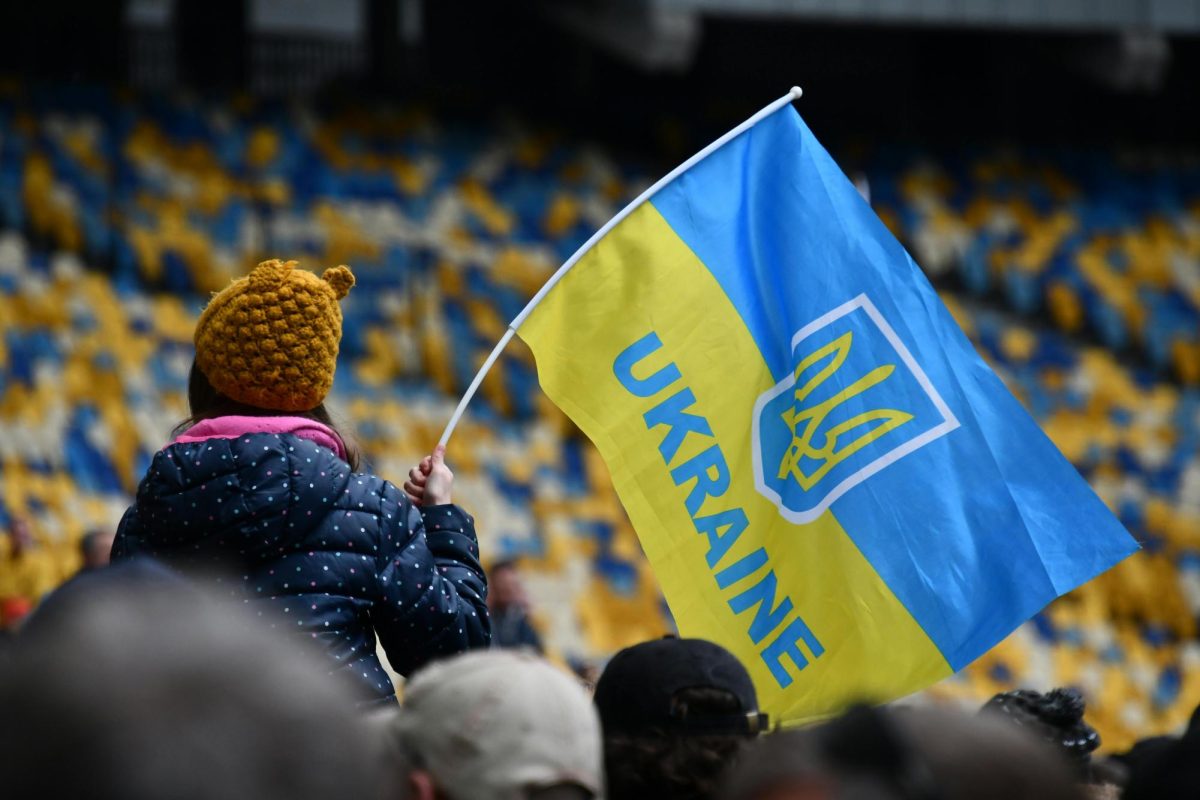 Child holds a Ukrainian flag