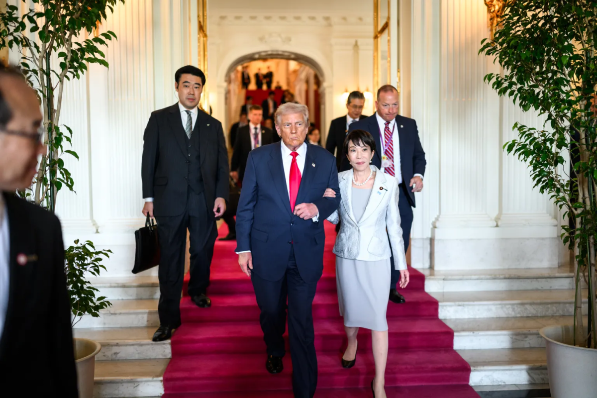 President Trump and Prime Minister Takaichi walking together during their meeting.