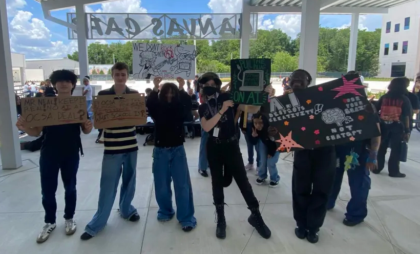 OCSA Students outside the cafeteria holding up anti-AI signs in protest.
